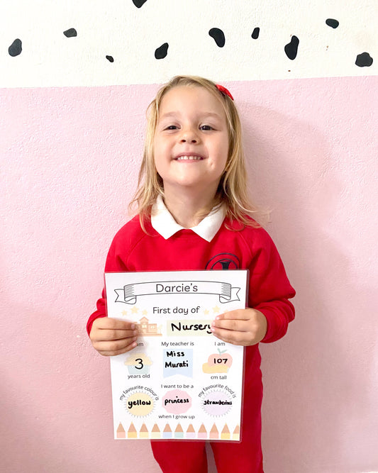 Child ready for their first day of reception with a Busby Busy Books first day sign