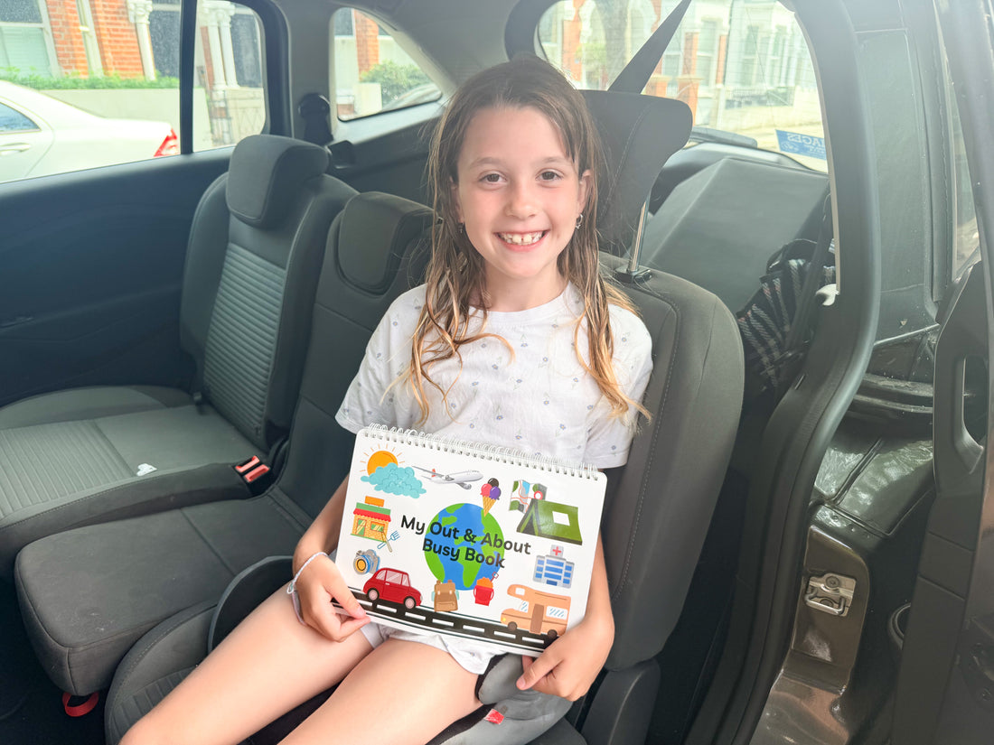 Child using an Out and About busy book in the car on a journey